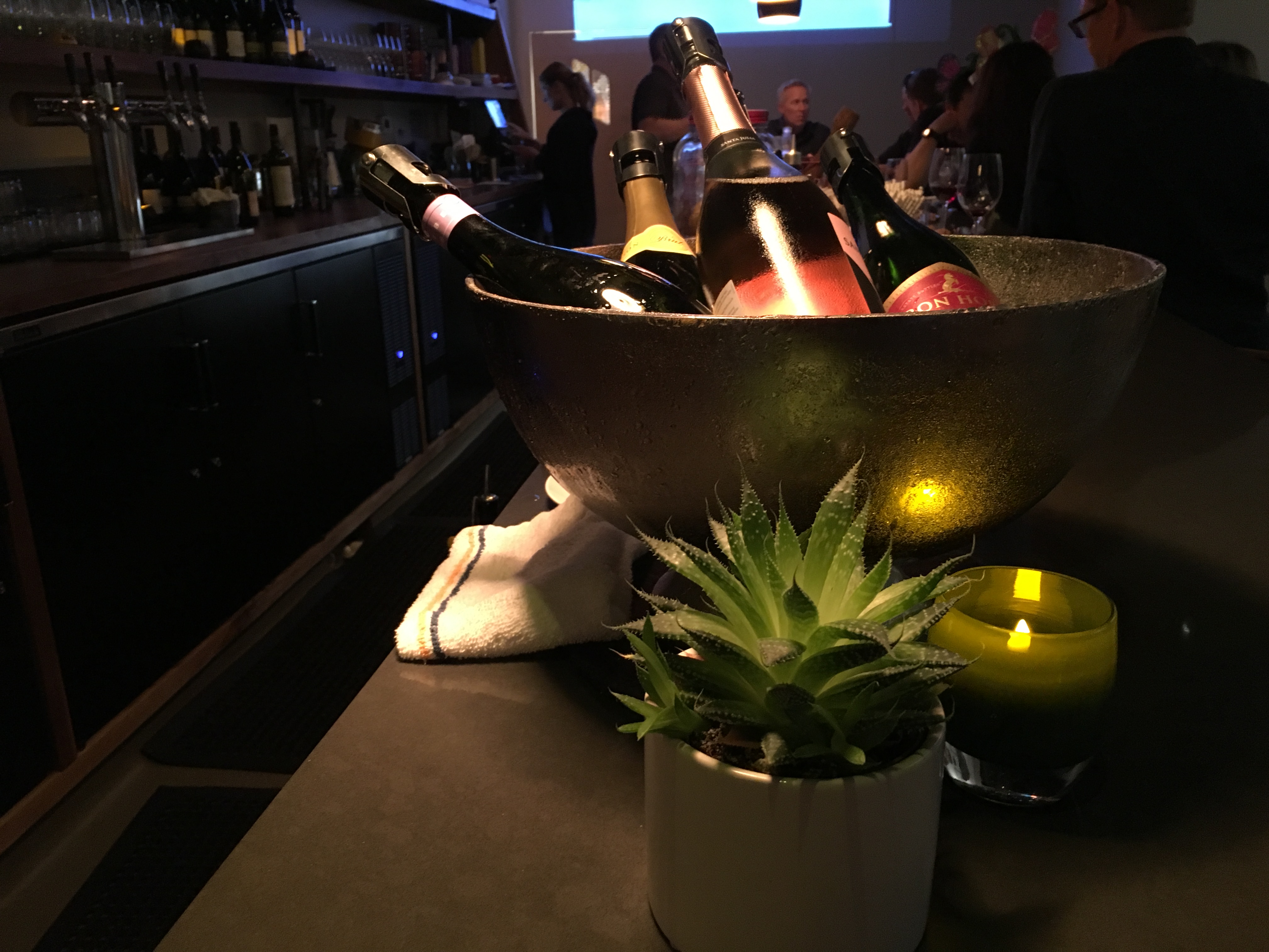 A photo of bottles of champagne, prosecco and sparkling rosé sit on the bar at the Honcho, a new hip local cocktail lounge in downtown Los Altos, California. Photo Courtesy of FoodWaterShoes