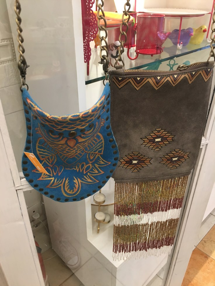 Beaded and Embellished Purses Hang from a Shelf at Crazy Daisy Boutique in New Delhi, India