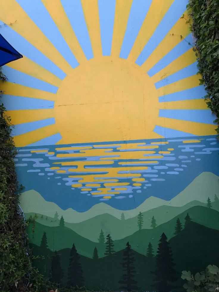 An Outdoor Sunshine Mural at Scrambl'z Restaurant in San Jose, California
