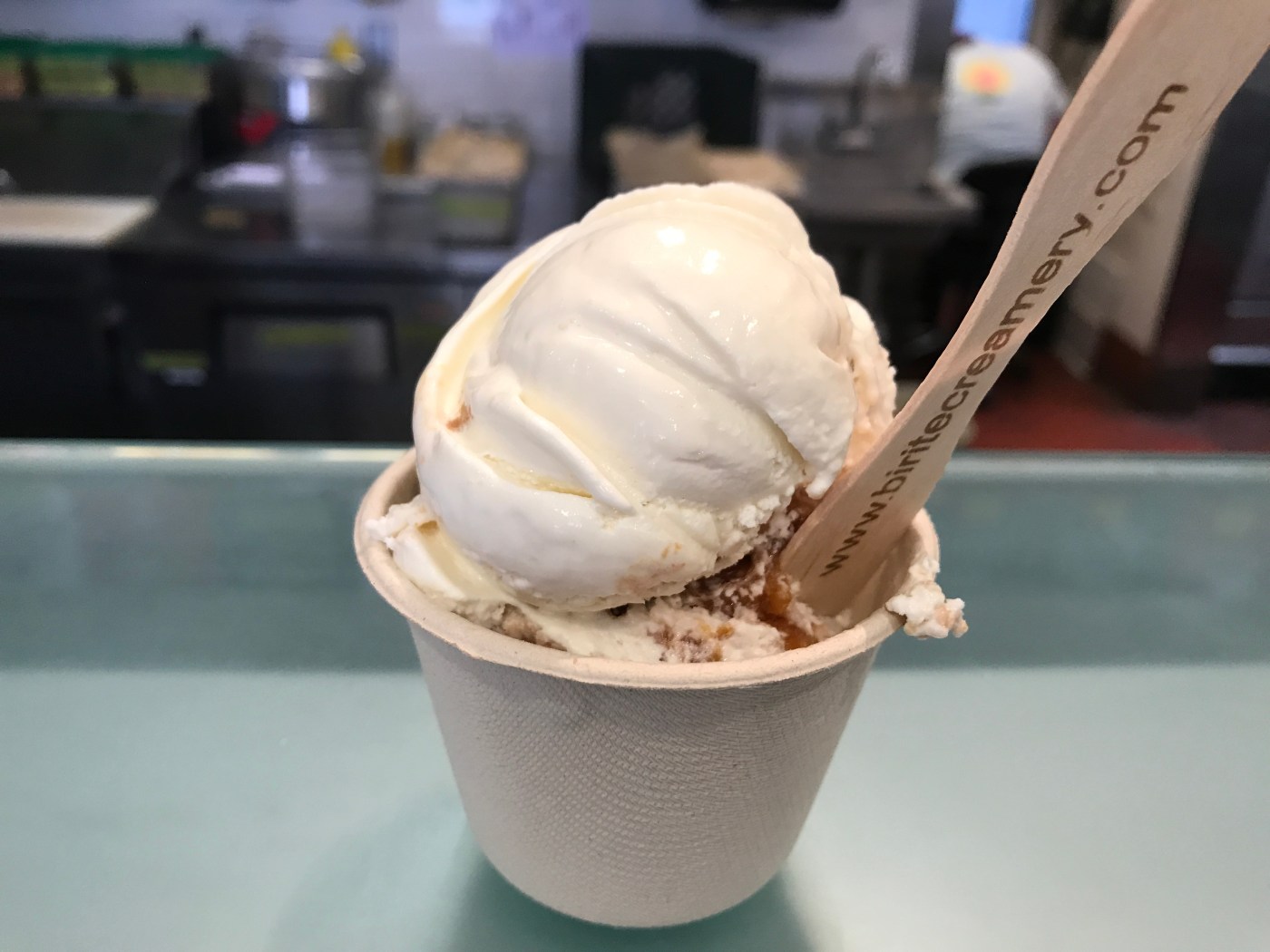 The Perfect Pair - A Scoop of Bi-Rite Creamery’s Peachy Cobbler Nestled Beside a Scoop of Basil Ice Cream in San Francisco