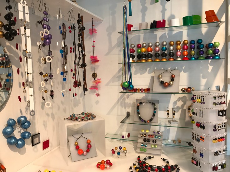 Accessories of Color - One of the Wall Displays Filled with Bracelets, Candlesticks, Earrings and Necklaces by Local Designers at ​Kirsuberjatréð in Reykjavík, Iceland