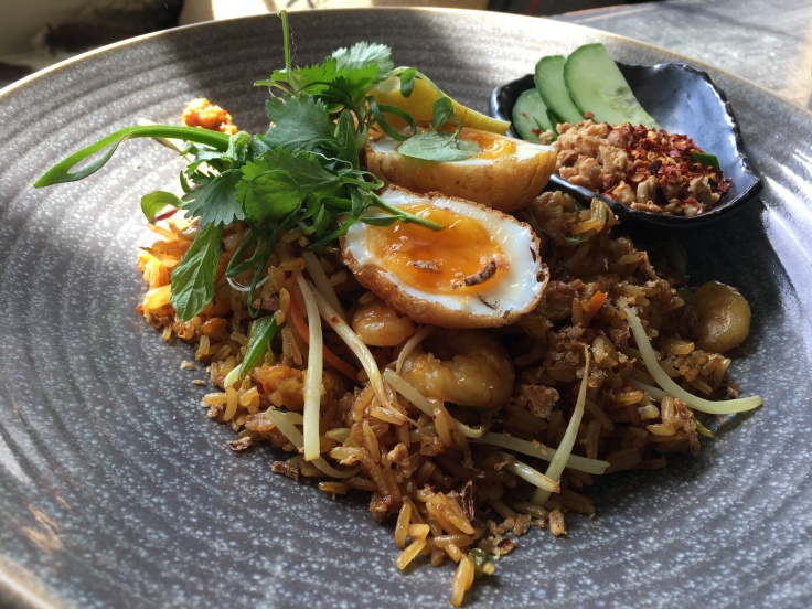 Nasi Goreng Made with Fried Fragrant Jasmine Rice, Tiger Prawns, Free Range Chicken, Chili, Shallots, Bean Sprouts, Peanuts and a Son-in-Law Egg