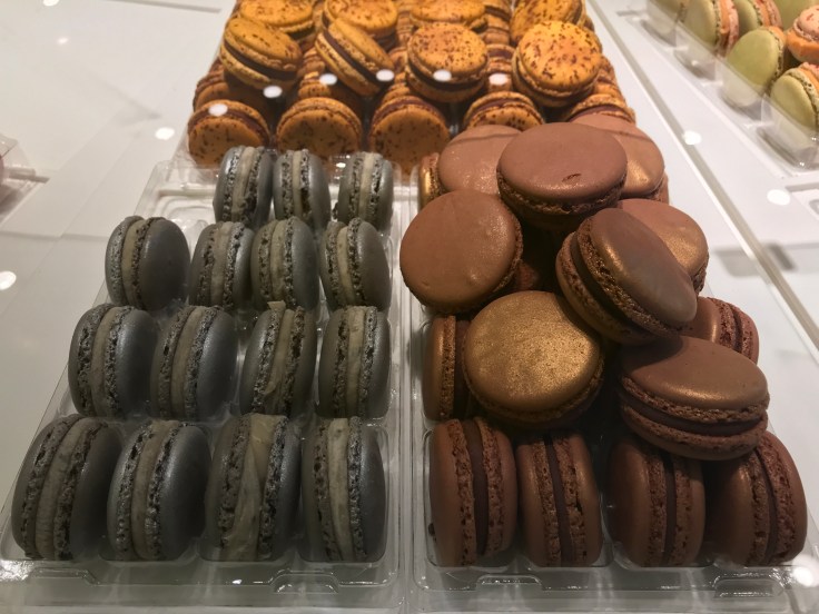 From Left to Right - Silver Caviar Petrossian, Glittering Chocolate Foie Gras and Golden Milk Chocolate Passion Fruit Macarons at Pierre Hermé in Paris, France
