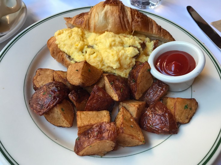 Brunch Hero - A Croissant Sandwich Made With Scrambled Eggs, Cheddar Cheese and Sausage at Café de la Presse in San Francisco, California
