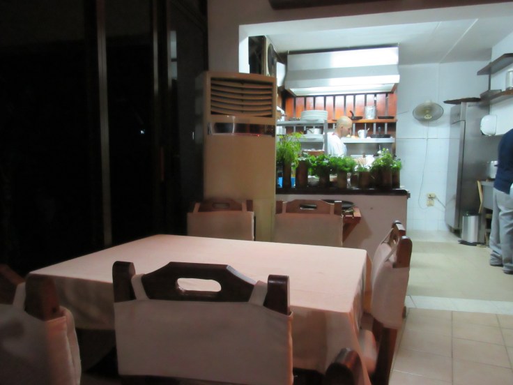 A Table With a Garden View Into the Kitchen at El Romero in Las Terrazas, Cuba