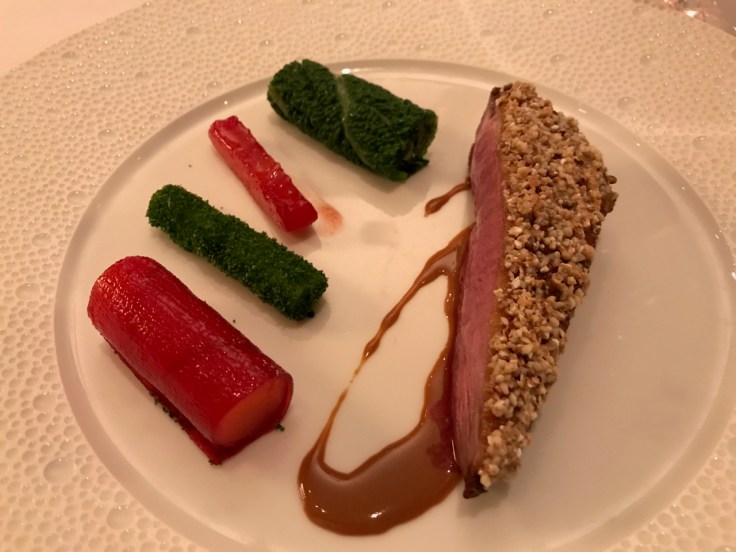 A photo of canard de Challans croûte de dragées légumes d'hiver en aigre doux (Challans duck with a Jordan almond crust served with sweet and sour winter vegetables) at Le Taillevent in Paris, France.