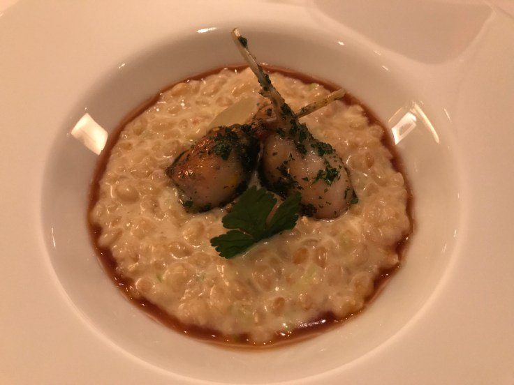 A photo of peautre du Pays de Sault cuisiné comme un risotto avec cuisses de grenouilles dorées (delicious spelt from the Pays de Sault region of France cooked risotto style and served with frog legs at Le Taillevent in Paris.