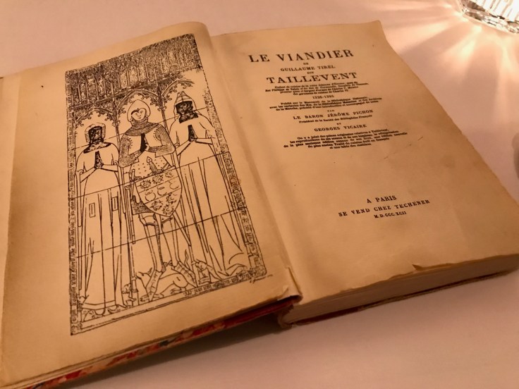 A photo of a copy of the fourteenth century cookbook Le Viandier at Le Taillevent in Paris, France.