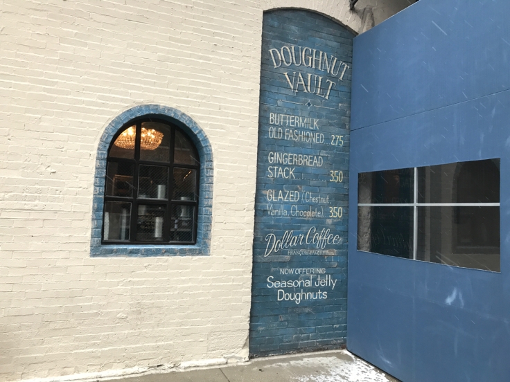 An exterior photo of the storefront of the Doughnut Vault in Chicago, Illinois taken from the street.
