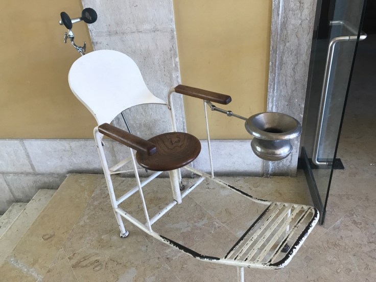 An antique examination chair on display at the pharmacy inspired restaurant called Pharmacia in Lisbon, Portugal.