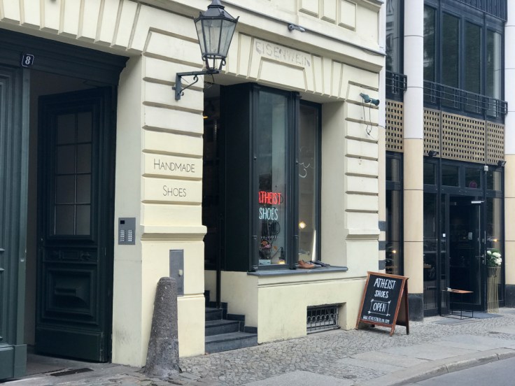 A street view photo of the outside of Atheist Shoes from the sidewalk in Berlin, Germany.