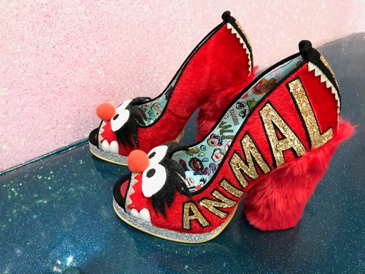 A photo of bright red shoes that have a fuzzy red high heel at Irregular Choice in London, England. The louder, louder shoes were inspired by animal a character on Sesame Street.