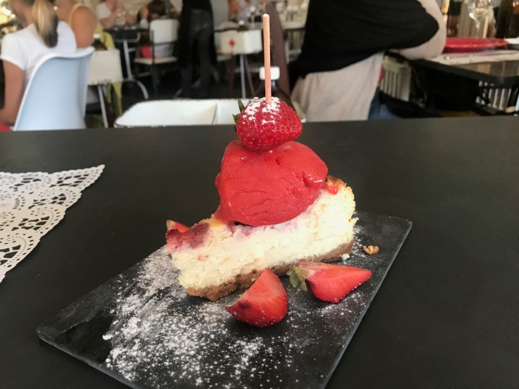 A slice of goat cheese pie topped with strawberry slushie is served for dessert at Pharmacia restaurant in Lisbon, Portugal. (Tarte de queijo cabra com granizado de morango)