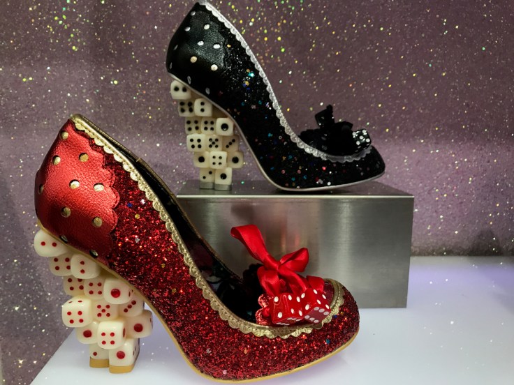 A photo of the up the ante high heels at Irregular Choice in London, England. The designs are in red and black glitter and the heel of each shoe is made out of dice.