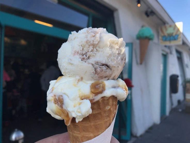 An ice cream cones with a soop of banana Nutella sitting on top of salted peanut and caramel (salthnetu og karamellu) at Ísbúðin Valdís (a small little local ice cream shop) in Reykjavík, Iceland.