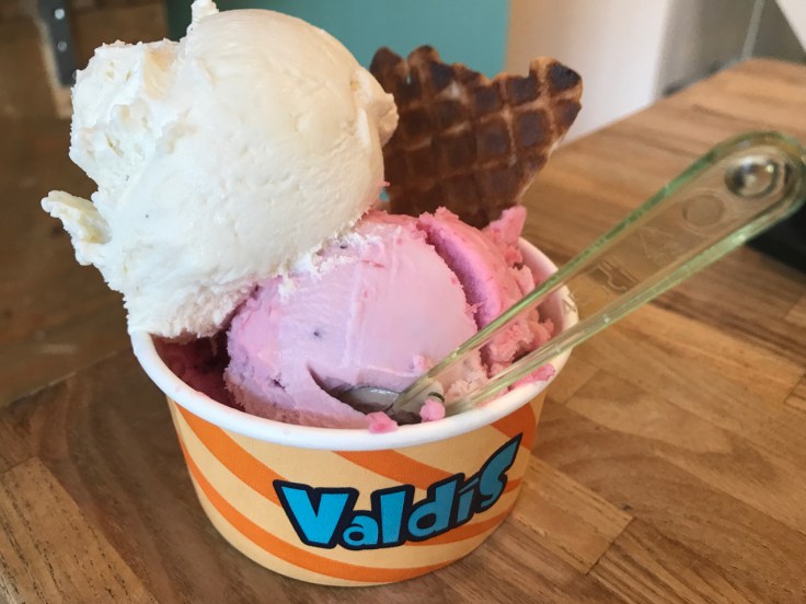 A cup filled with a scoop of crowberry and rhubarb sorbet (krækiberjaskyr og rabarbara) at Ísbúðin Valdís ice cream shop in Reykjavík, Iceland via FoodWaterShoes.