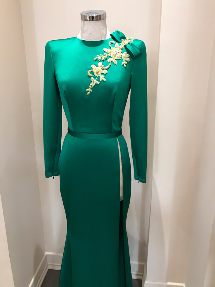 An emerald green gown with gold floral embroidery and beading. The silk high slit dress is on display at João Rôlo Couture (a haute local couture atelier boutique in Lisbon, Portugal). Photo Courtesy of FoodWaterShoes
