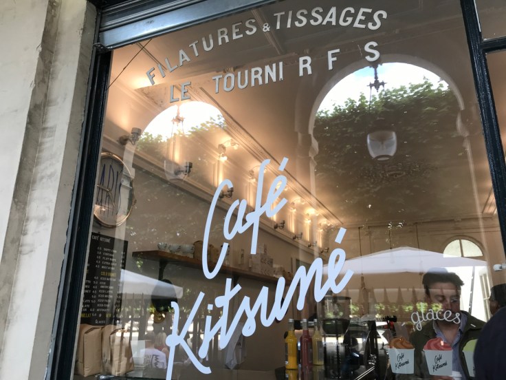 An exterior street view photo of taken from the sidewalk outside the front of Café Kitsuné restaurant in Paris, France. Photo Courtesy of FoodWaterShoes