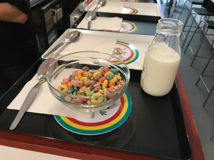 An old school cafeteria tray gets prepped with Kellogg's Froot Loops and a jug of milk at Pop Cereal Café in Porto, Portugal.