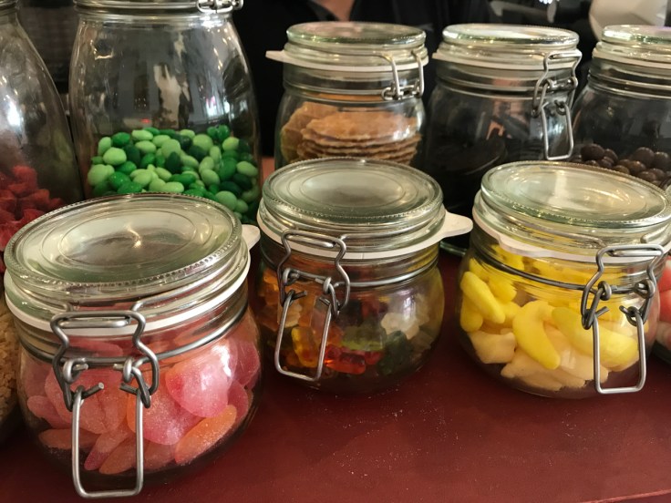 Glass jars filled with cereal toppings on display at Pop Cereal Café in Porto, Portugal. The restaurant offers everything from After Eight Mint M&M's to sour peaches and gummy bears.