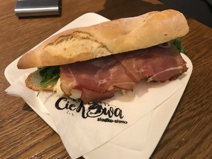 A ham and cheese sandwich with greens served on baguette for lunch at Ciekawa Słodko-Słono ice cream shop and restaurant in Tarnów, Poland.