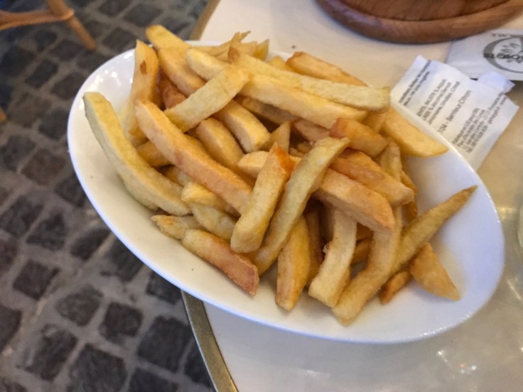A plate of French fries (frites) at Au Pied de Cochon restaurant in Paris, France.