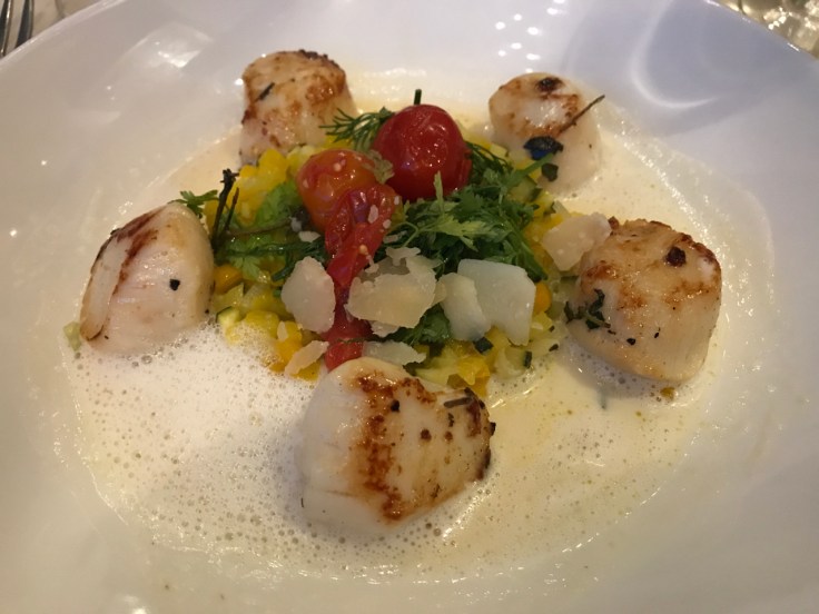 Scallops with lemongrass emulsion, vegetables and parmesan (noix de Saint Jacques émulsion aux coquillages, niçoise de légumes et parmesan) at Au Pied de Cochon restaurant in Paris, France.