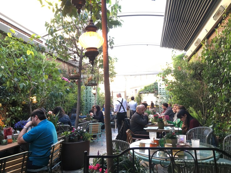 Bird cages hang from trees and fresh flowers decorate the secret garden at El Jardín de SB (Salvador Bachiller) restaurant in Madrid, Spain.