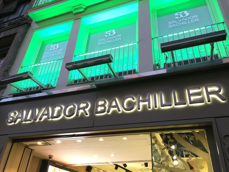 An exterior street view photo from the sidewalk outside of Salvador Bachiller's accessories shop and home of the SB Gastrobares including El Jardín de SB in Madrid, Spain. Photo Courtesy of FoodWaterShoes