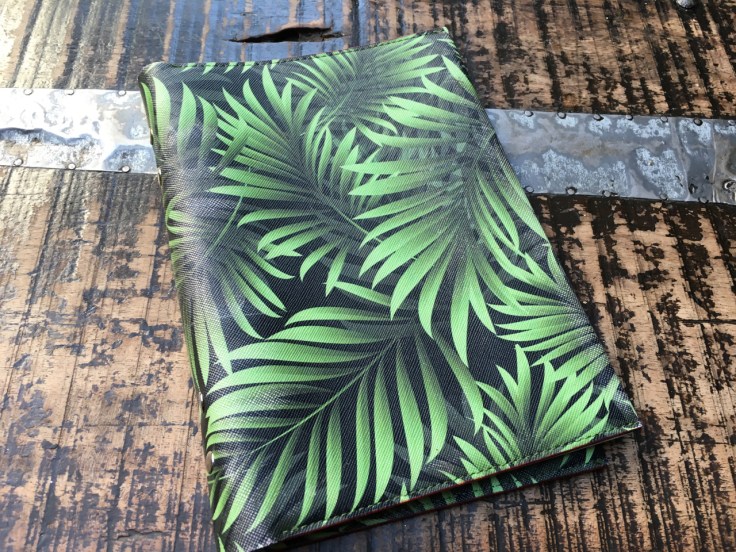 Beautiful green leather palm print menu covers decorate a table at El Jardín de SB (Salvador Bachiller) restaurant in Madrid, Spain.