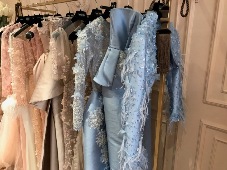 Feathered and beaded peach and baby blue dresses on display at João Rôlo Couture (a haute couture gown atelier in Lisbon, Portugal). Photo Courtesy of FoodWaterShoes