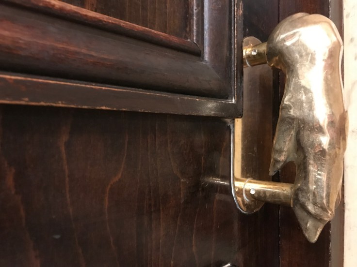 A pig's foot door handle at Au pied de Cochon restaurant in Paris, France.