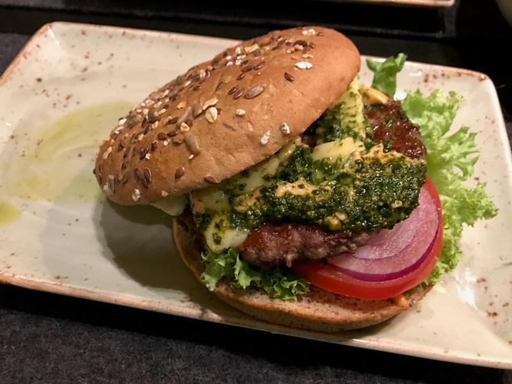 A träumer brie and pesto burger on a wheat bun filled with tomato, lettuce and red onions at Hans im Glück burger grill and restaurant in Stuttgart, Germany. Photo Courtesy of FoodWaterShoes