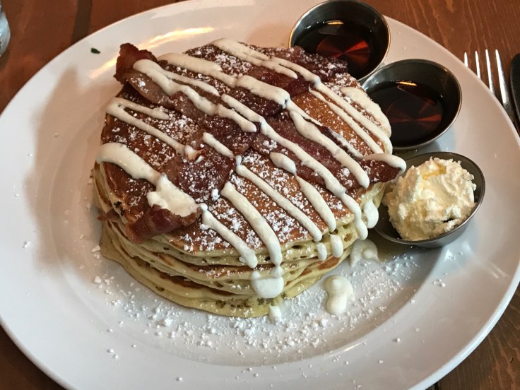 Bacon stuffed pancakes topped with even more bacon and sour cream drizzle at Mo's Breakfast + Burger Joint in Campbell, California. Photo Courtesy of FoodWaterShoes