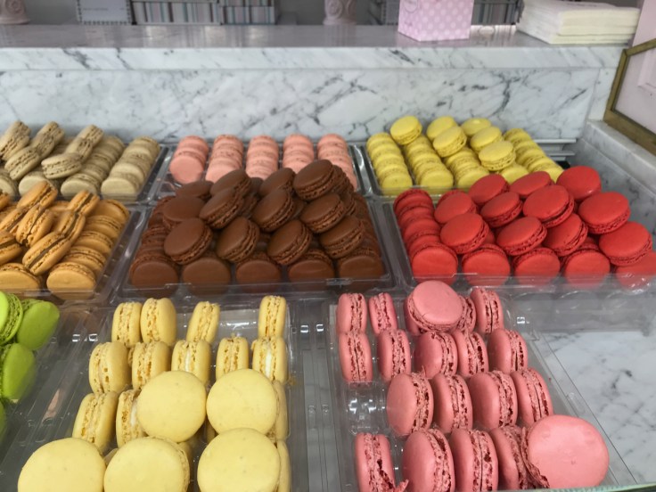 Brown, pink, red, yellow and green macarons on display at Cafeé Pouchkine in Paris, France. Photo Courtesy of FoodWaterShoes