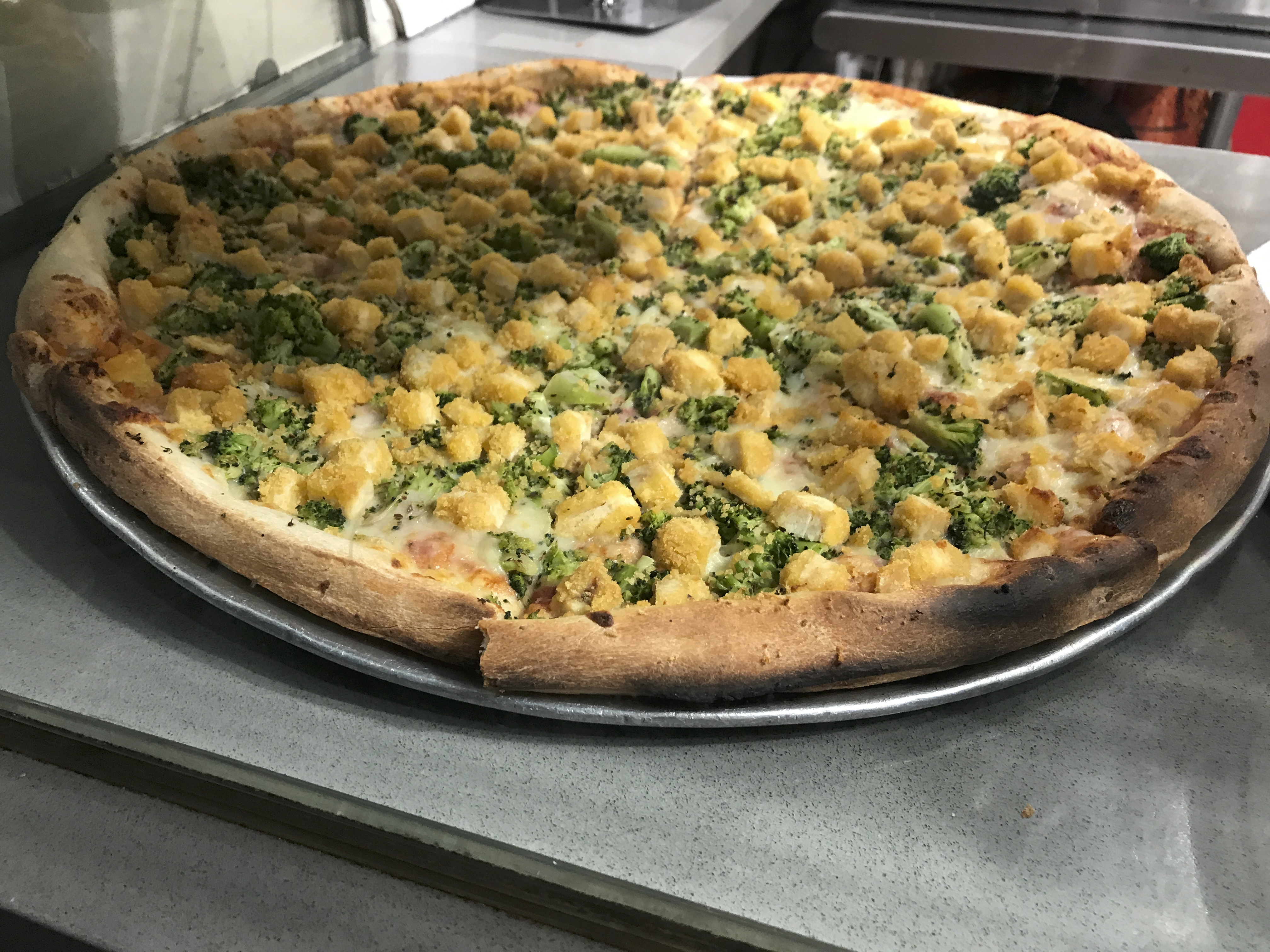 I Only Have Pies for You - A photo of broccoli and chicken slices at 2 Bros. Pizza restaurant in New York City, New York. Photo Courtesy of FoodWaterShoes