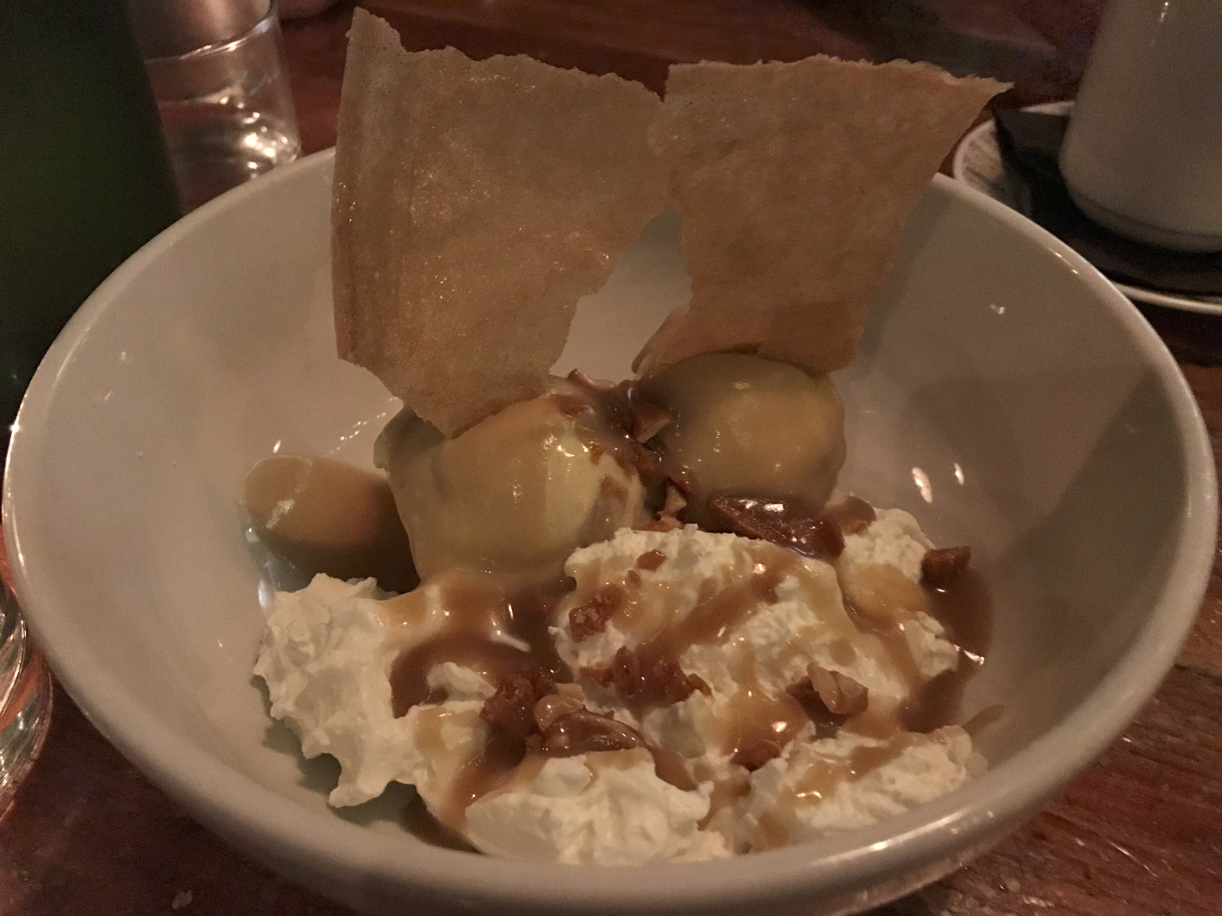 A photo of the banana sundae at local hot spot Mindy's Hot Chocolate Chicago in Chicago, Illinois. The dessert is made with banana halvah ice cream, warm butterscotch, peanut brittle and graham cracker. The Windy City based dessert restaurant serves brunch, cocktails, drinks, lunch and dinner. Photo Courtesy of FoodWaterShoes