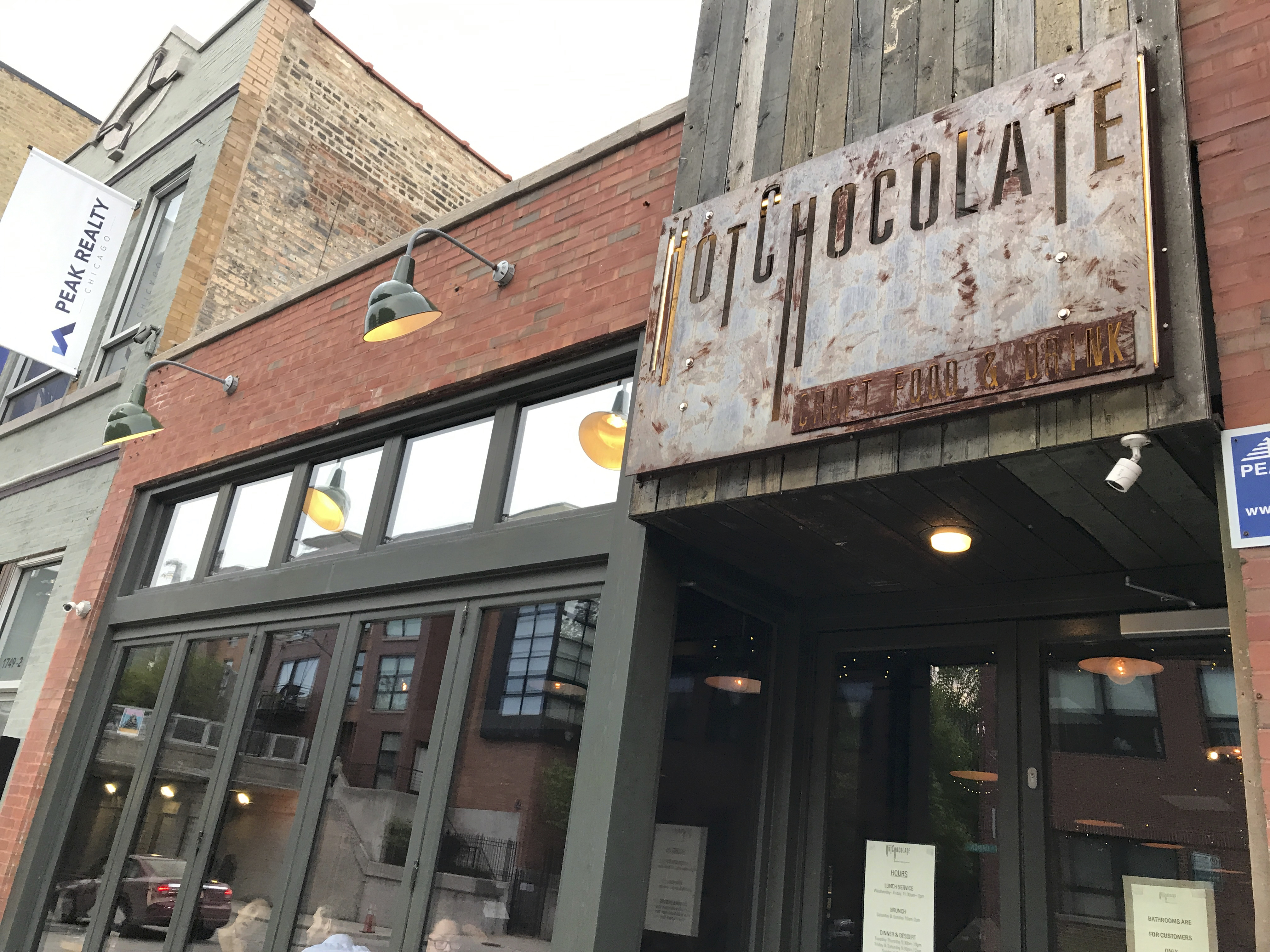 An exterior street view photo of Mindy's Hot Chocolate Chicago, a dinner and dessert restaurant in Chicago, Illinois. This is a picture of the outside front of the Windy City comfort food spot. Photo Courtesy of FoodWaterShoes.