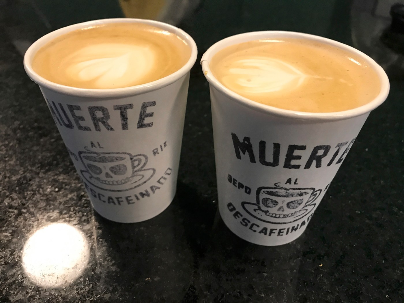 A photo of two delicious tasty hot cappuccinos at Nómade, a café in Montevideo, Uruguay. Photo Courtesy of FoodWaterShoes