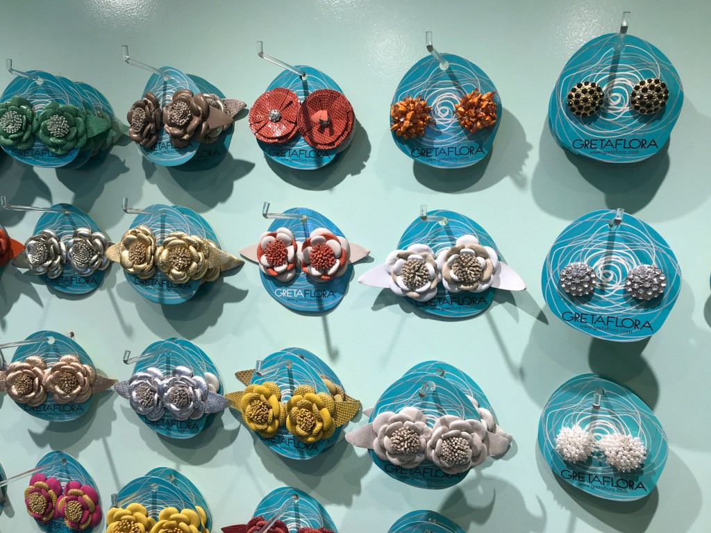 A photo of a wall full of clip on high heel flower accessories at the GretaFlora shoe shop in Buenos Aires, Argentina. If you're interested in fashion and high heel shopping in Buenos Aires, this is one boutique you won't want to miss. Photo Courtesy of FoodWaterShoes