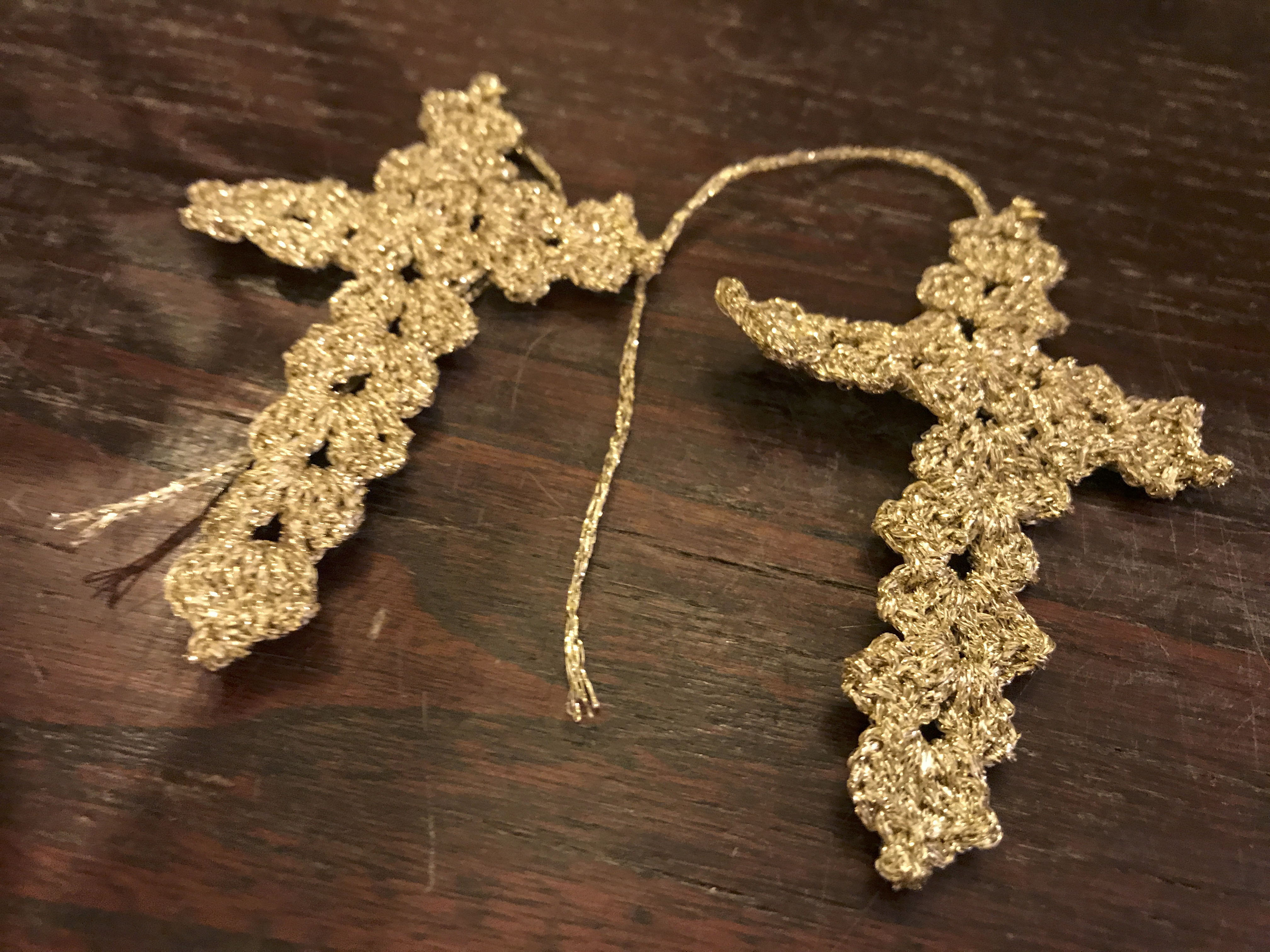 A photo of handmade cross shaped crochet earrings still in the works at Sikuliana Art Atelier in Florence, Italy. Photo Courtesy of FoodWaterShoes