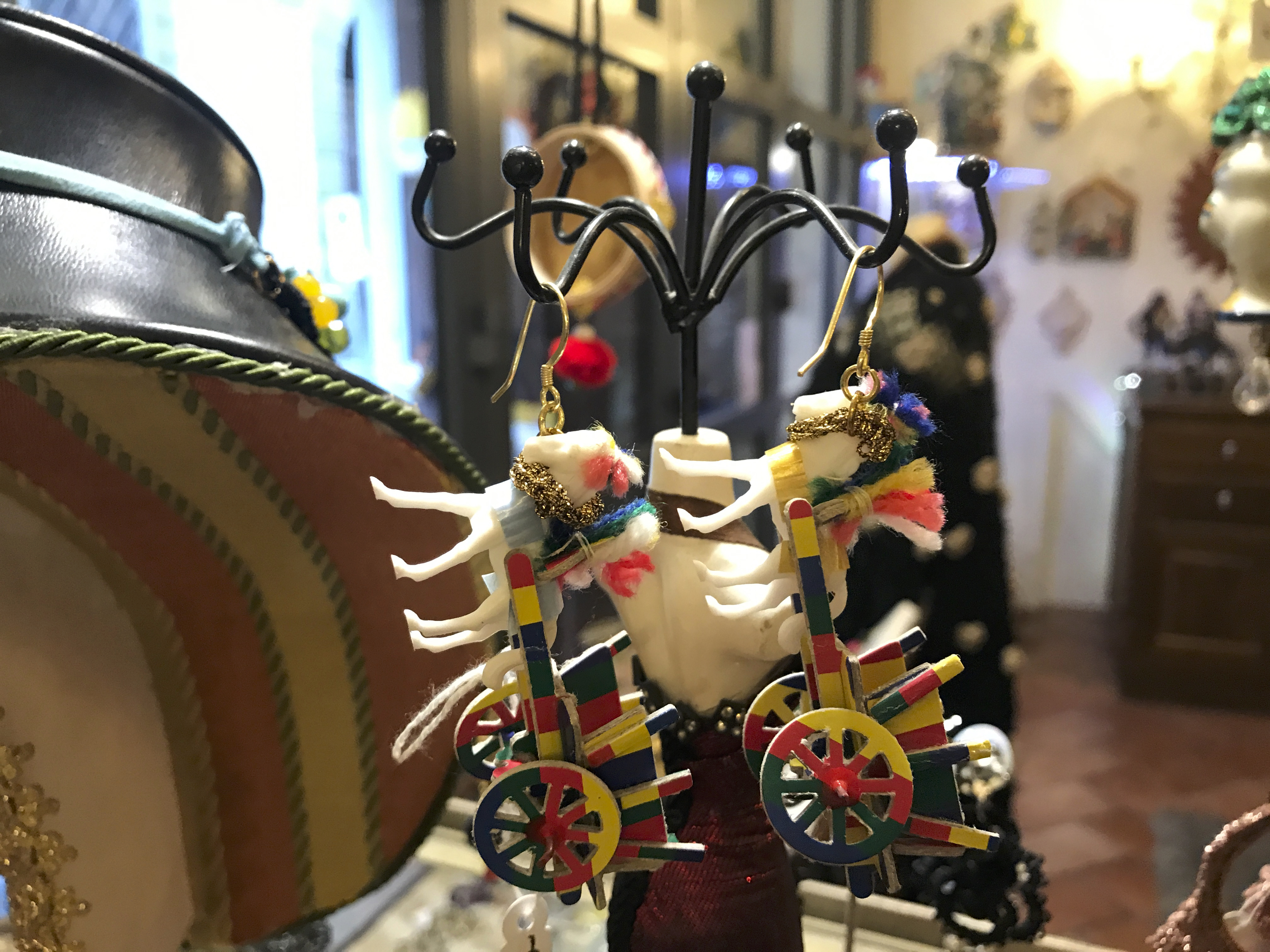 A photo of handmade horse or donkey cart earrings at Sikuliana Art Atelier in Florence, Italy. Photo Courtesy of FoodWaterShoes