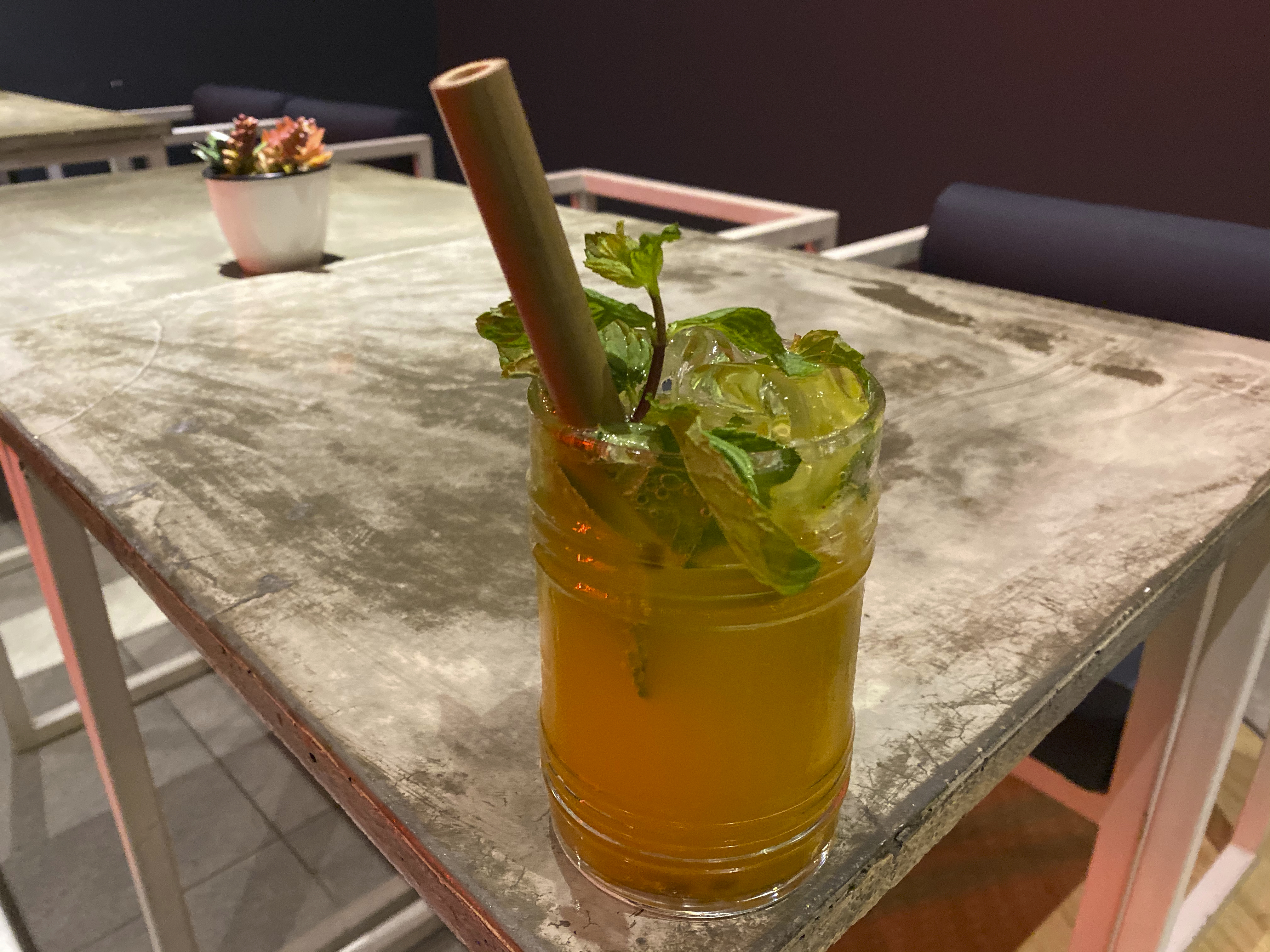 A photo of a mint and passion fruit virgin mojito on a table at Baozi باوزي restaurant in Riyadh, Saudi Arabia. Photo Courtesy of FoodWaterShoes