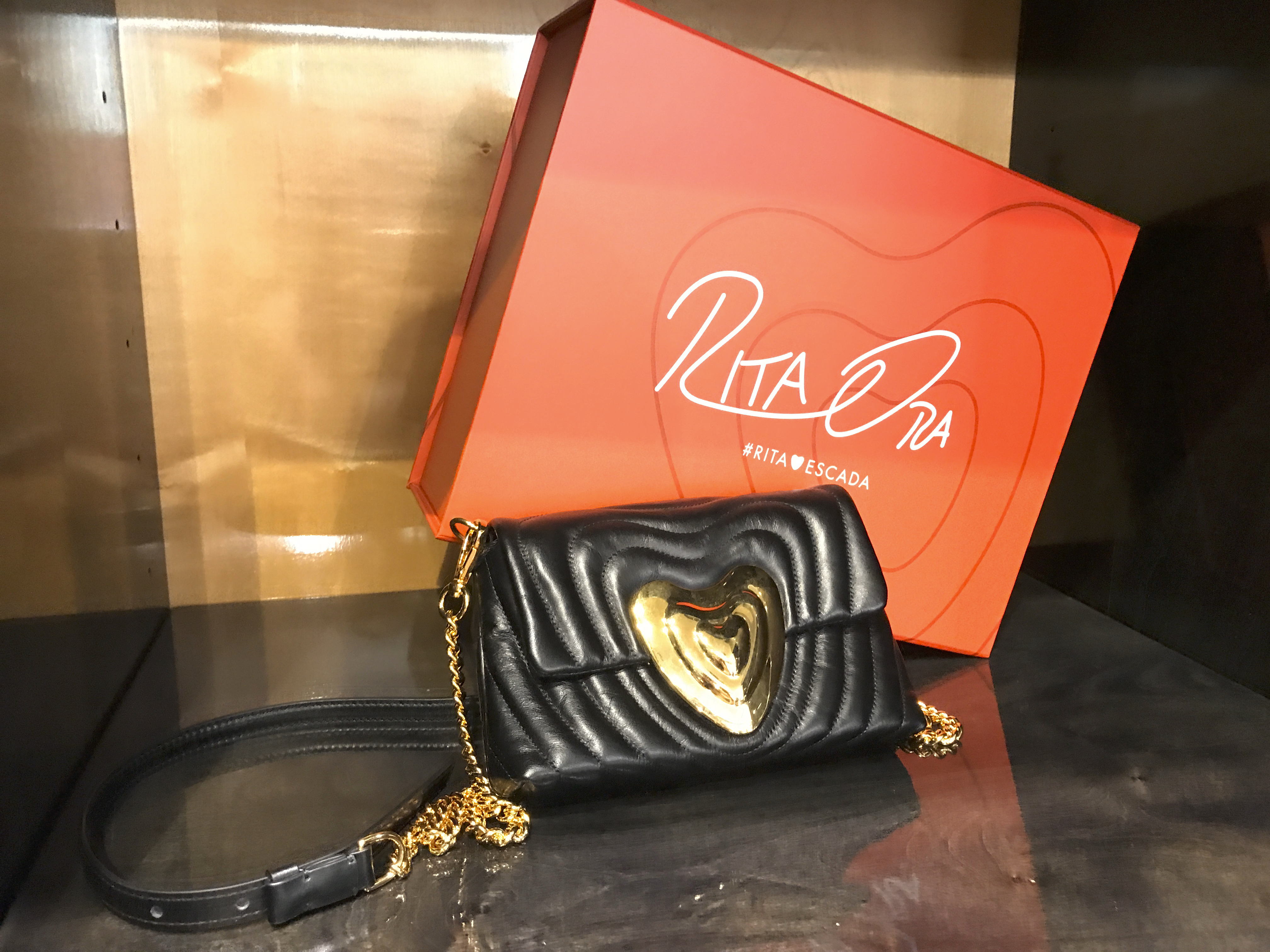 A photo of a Rita Ora designed black leather Escada heart bag at Bottega Giuliana, a cute boutique in Verona, Italy. The rare purse features gorgeous gold accents and hardware. Photo Courtesy of FoodWaterShoes