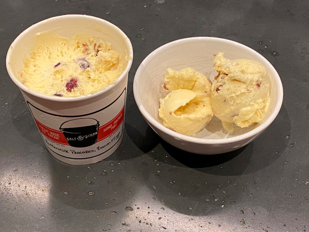 A photo of an ice cream pint and a bowl filled with an exotic flavor called buttermilk pancakes, bacon and eggs from Salt & Straw in California. Photo by FoodWaterShoes